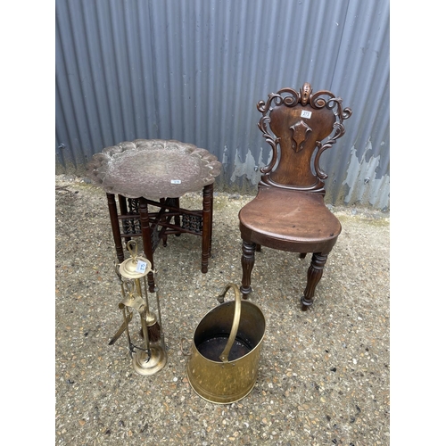 273 - A mahogany hall chair, a brass tray top table, a brass bucket and a brass companion set