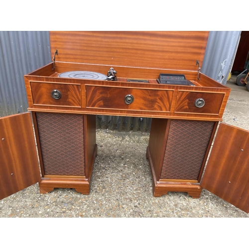 279 - A dynatron record deck with speakers all concealed within a yew writing desk cabinet with green leat... 