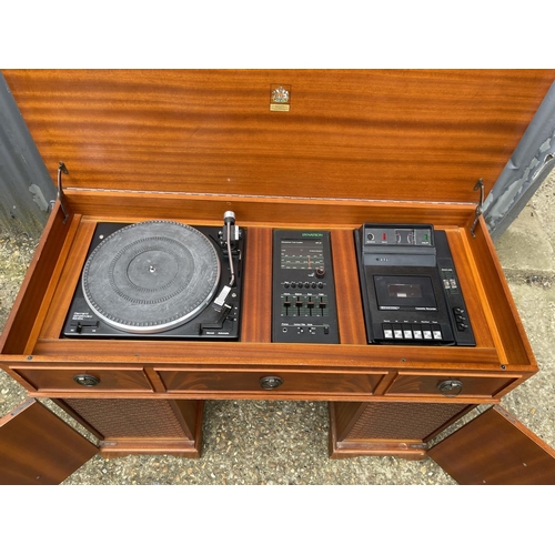 279 - A dynatron record deck with speakers all concealed within a yew writing desk cabinet with green leat... 