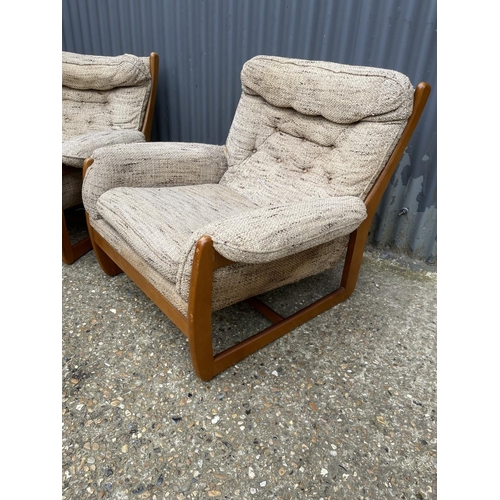 285 - A pair of teak framed mid century armchairs with oatmeal upholstered cushion seats