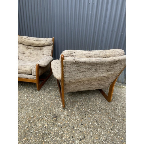 285 - A pair of teak framed mid century armchairs with oatmeal upholstered cushion seats