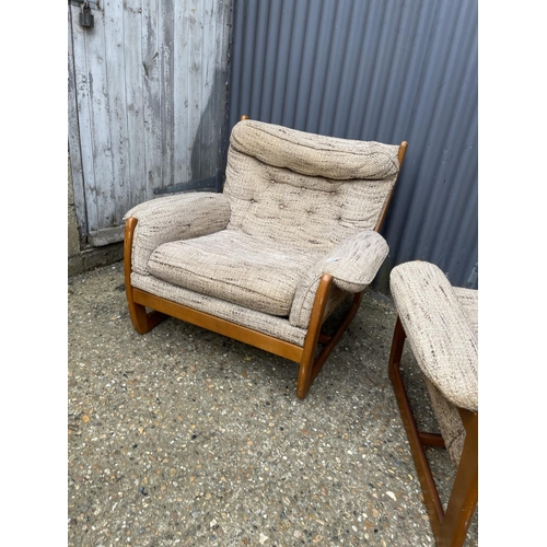 285 - A pair of teak framed mid century armchairs with oatmeal upholstered cushion seats