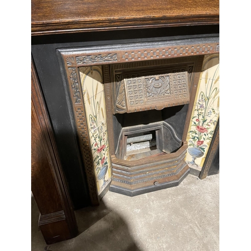 289 - A cast iron sitting room fire place with tiled features, together with oak fire surround with mirror... 