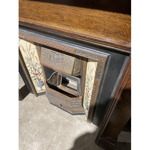 289 - A cast iron sitting room fire place with tiled features, together with oak fire surround with mirror... 