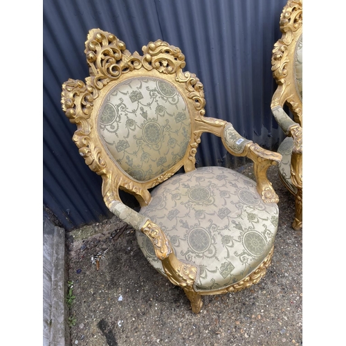 290 - A pair of very large gold gilt framed throne chairs with green pattern upholstery