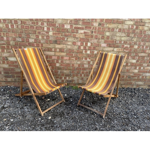 32 - A pair of striped deck chairs