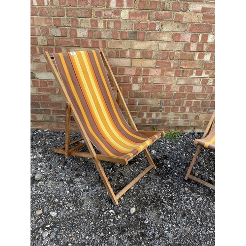 32 - A pair of striped deck chairs