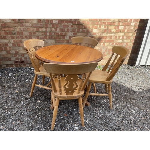 38 - A circular pine kitchen table and four chairs 90cm diameter