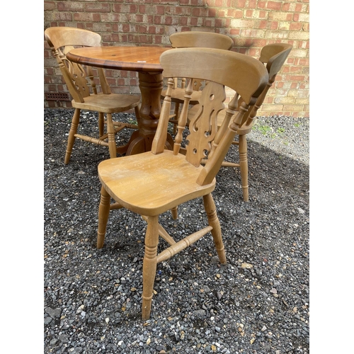 38 - A circular pine kitchen table and four chairs 90cm diameter