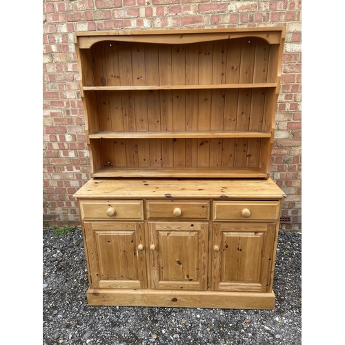 39 - A solid pine three drawer dresser with plate rack back 130x48 x177