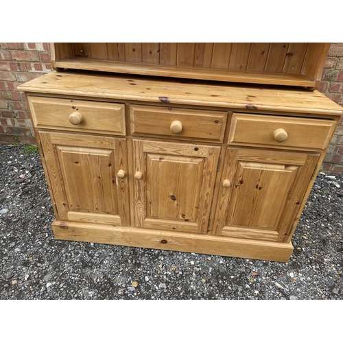 39 - A solid pine three drawer dresser with plate rack back 130x48 x177