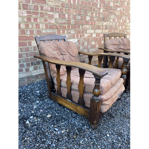 4 - A pair of early 20th century oak framed easy chairs with sliding seat and adjustable backs a/f