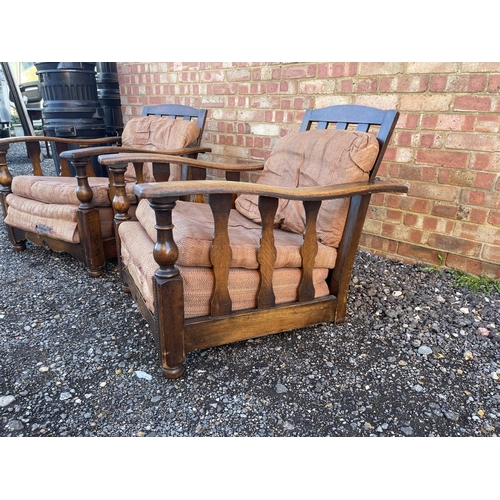 4 - A pair of early 20th century oak framed easy chairs with sliding seat and adjustable backs a/f