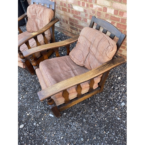 4 - A pair of early 20th century oak framed easy chairs with sliding seat and adjustable backs a/f