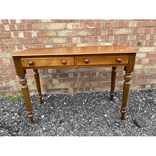 42 - A victorian mahogany two drawer writing table 107 wide