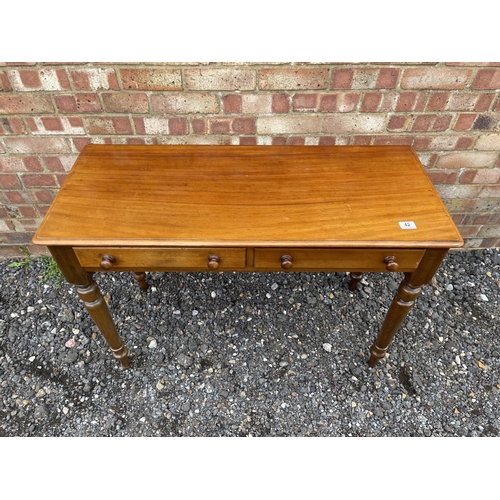 42 - A victorian mahogany two drawer writing table 107 wide