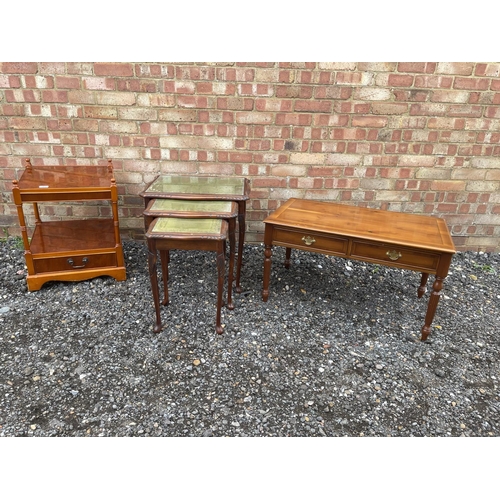 43 - A reproduction mahogany nest of three together with a yew coffee table and a yew book table