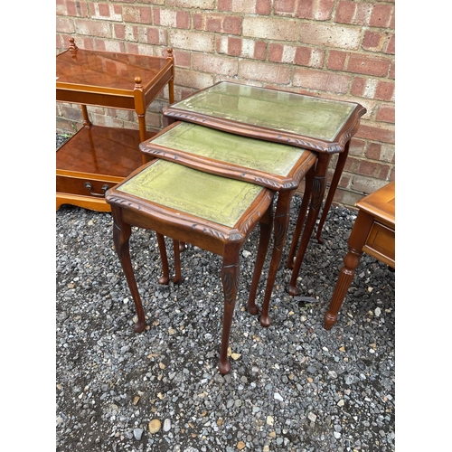 43 - A reproduction mahogany nest of three together with a yew coffee table and a yew book table