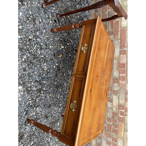 43 - A reproduction mahogany nest of three together with a yew coffee table and a yew book table