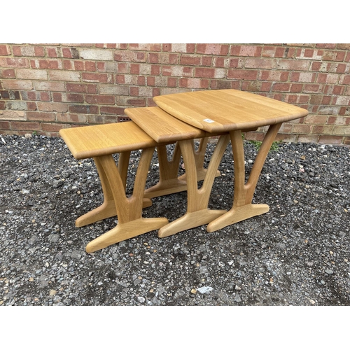 47 - A good quality light oak nest of three tables