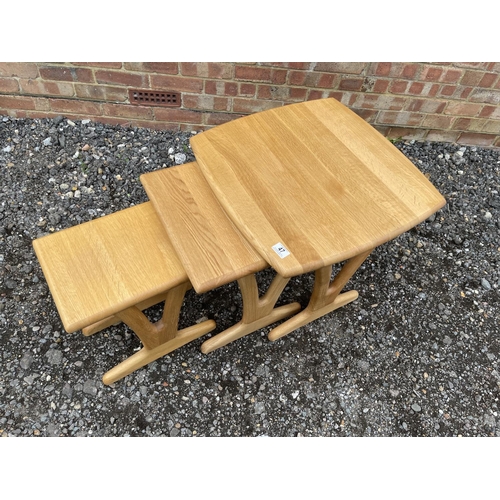 47 - A good quality light oak nest of three tables