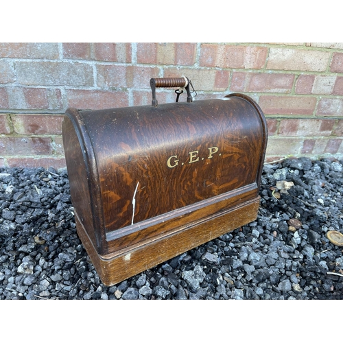 5 - An oak cased sewing machine with key