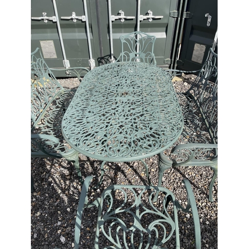 51 - A green aluminium oval garden table togther with two benches and two carver chairs 140x80