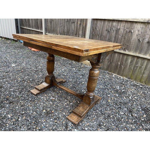 62 - An oak drawer leaf dining table