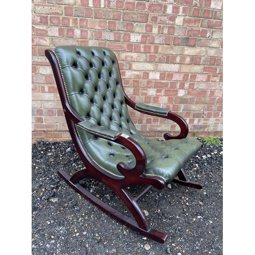 63 - A green leather chesterfield slipper rocking chair