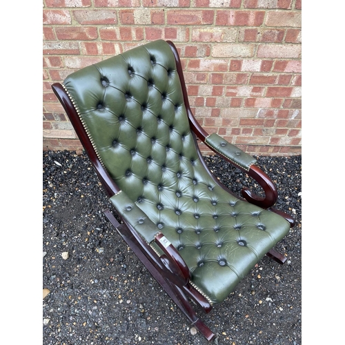 63 - A green leather chesterfield slipper rocking chair