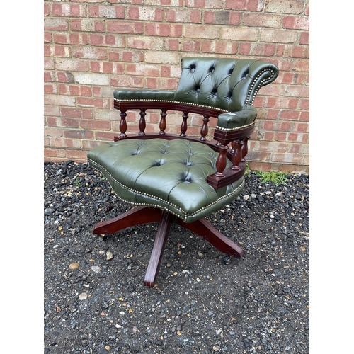 64 - A green leather chesterfield captains swivel desk chair