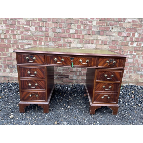 65 - A reproduction mahogany twin pedestal desk with a green leather top