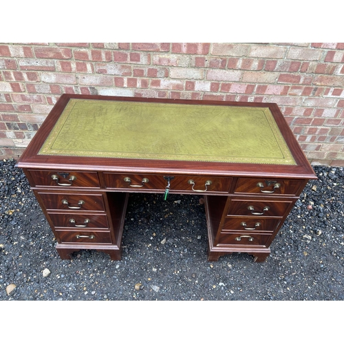 65 - A reproduction mahogany twin pedestal desk with a green leather top