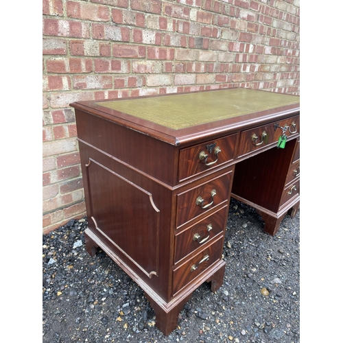 65 - A reproduction mahogany twin pedestal desk with a green leather top