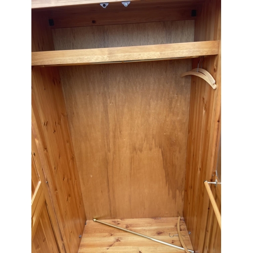 67 - A solid pine double wardrobe 97x 58x158