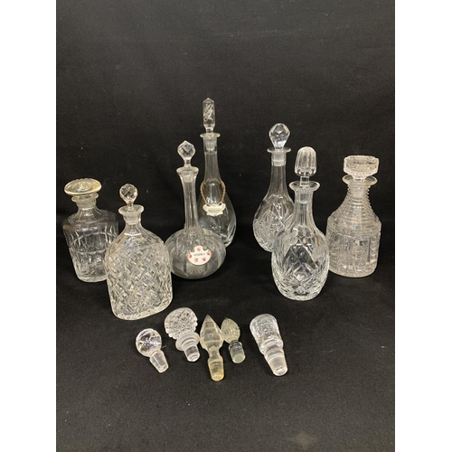 689 - Seven glass Decanters and five spare stoppers