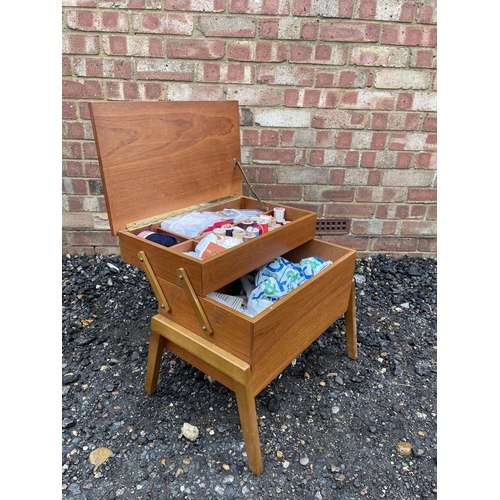 73 - A  mid century teak sewing box loaded with sewing accessories