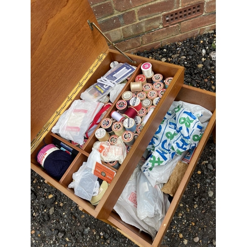 73 - A  mid century teak sewing box loaded with sewing accessories