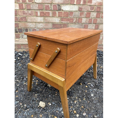 73 - A  mid century teak sewing box loaded with sewing accessories