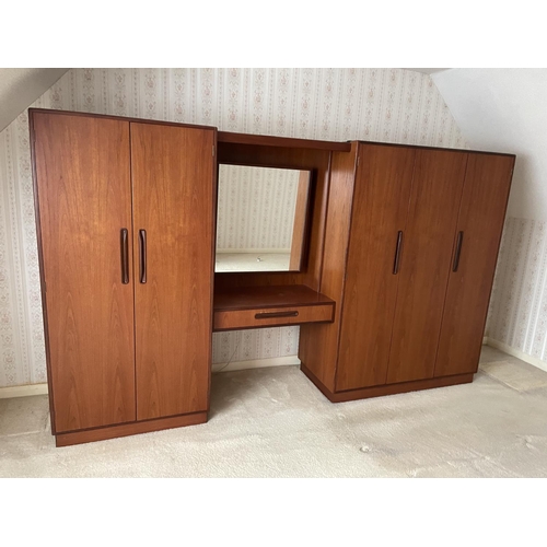 77 - A large g plan teak bedroom wardobe / dressing table suite consisiting of double wardobe, triple war... 