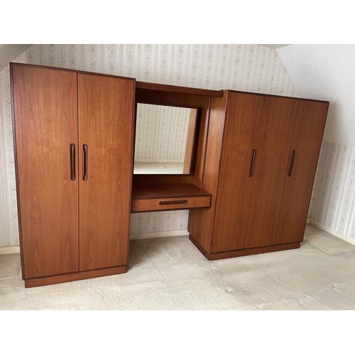 77 - A large g plan teak bedroom wardobe / dressing table suite consisiting of double wardobe, triple war... 