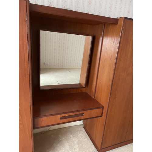 77 - A large g plan teak bedroom wardobe / dressing table suite consisiting of double wardobe, triple war... 