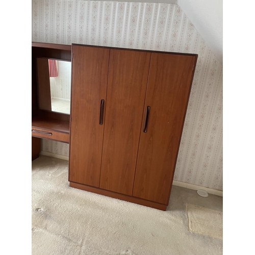 77 - A large g plan teak bedroom wardobe / dressing table suite consisiting of double wardobe, triple war... 