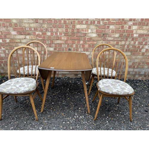 85 - An ercol golden dawn drop leaf table together with four ercol stick-back chairs