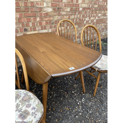 85 - An ercol golden dawn drop leaf table together with four ercol stick-back chairs