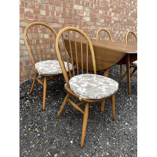 85 - An ercol golden dawn drop leaf table together with four ercol stick-back chairs