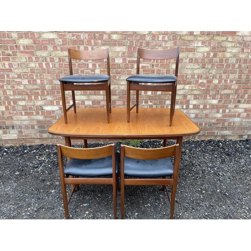 90 - A mid century g plan teak extending dining table together with four chairs by BATH CABINET MAKERS 15... 