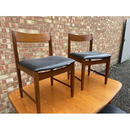 90 - A mid century g plan teak extending dining table together with four chairs by BATH CABINET MAKERS 15... 