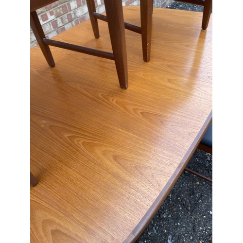 90 - A mid century g plan teak extending dining table together with four chairs by BATH CABINET MAKERS 15... 