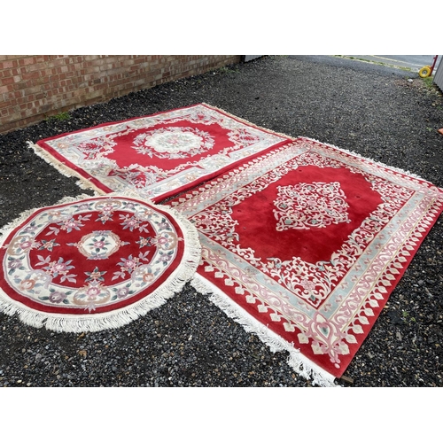 93 - A set of three large Chinese pattern carpets, two rectangular and one circular largest 290x 185